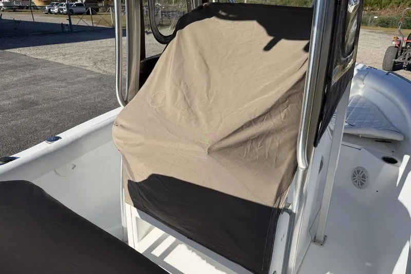 Slide: The Image of 2010 Sea Hunt Ultra 210 boat with covered console in a sunny outdoor setting. - 10