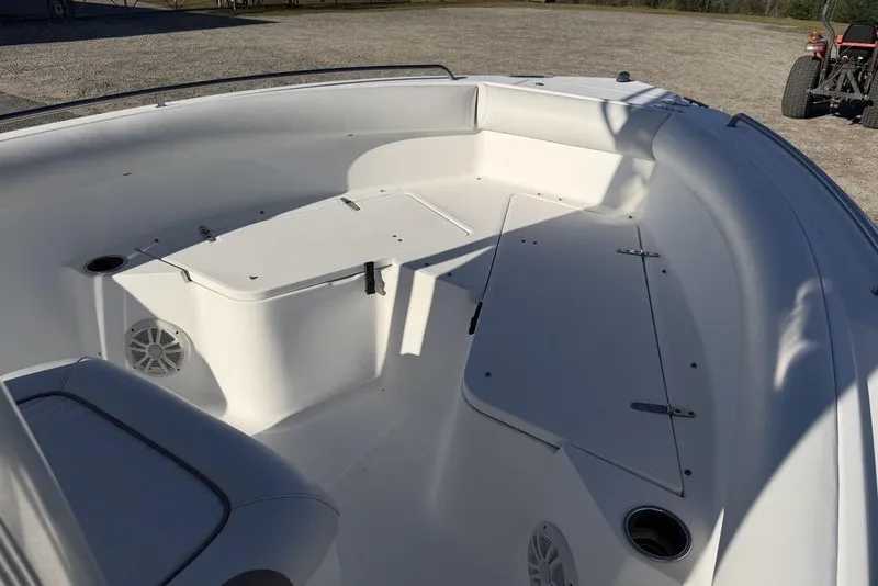 Slide: The Image of 2010 Sea Hunt Ultra 210 boat interior with seating and storage compartments. - 11