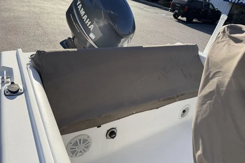 Slide: The Image of 2010 Sea Hunt Ultra 210 boat with Yamaha outboard motor, covered seating area. - 13