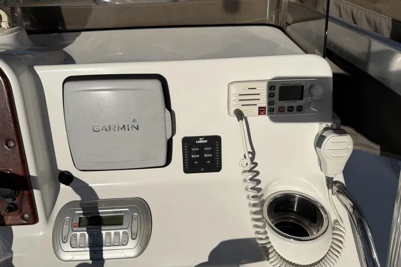 Slide: The Image of Control panel of a 2010 Sea Hunt Ultra 210 boat with Garmin and radio equipment. - 17