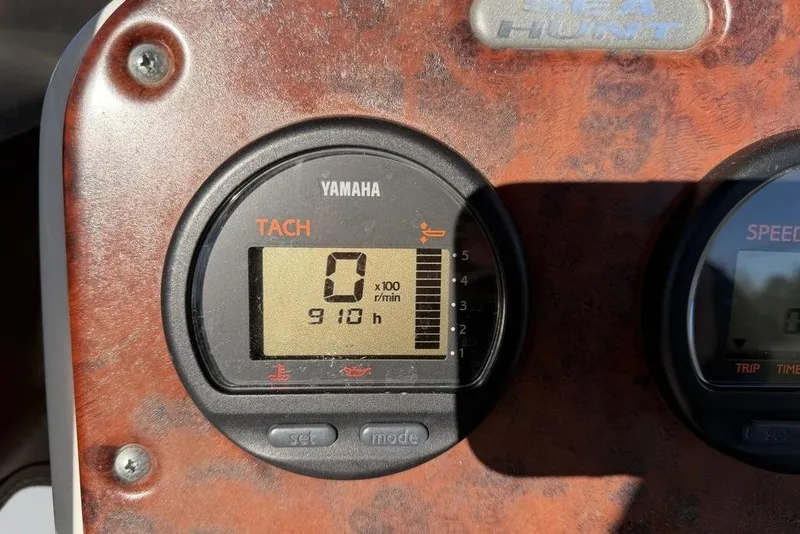 Slide: The Image of Yamaha tachometer on 2010 Sea Hunt Ultra 210 boat dashboard, showing 910 hours. - 18