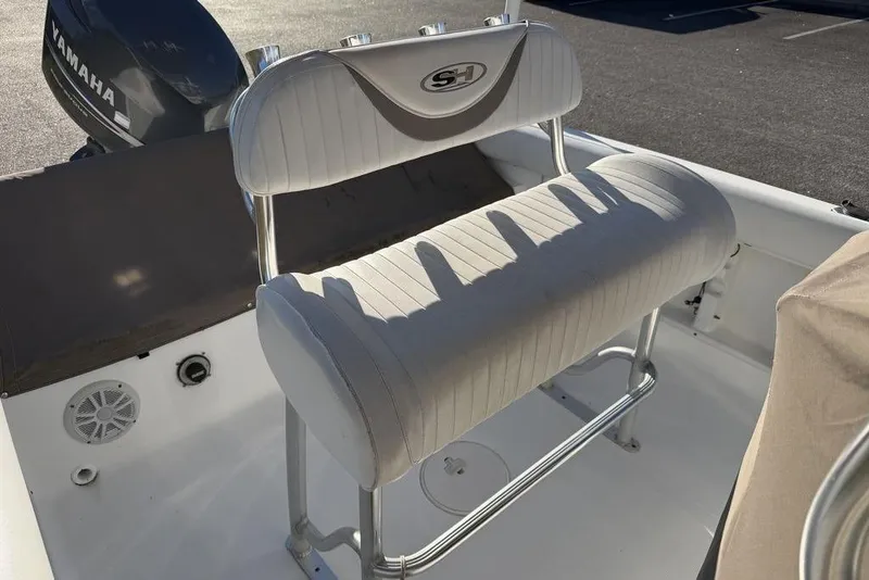 Slide: The Image of 2010 Sea Hunt Ultra 210 boat interior with Yamaha engine and cushioned seating. - 20