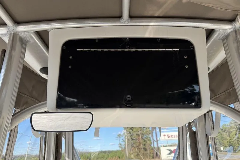 Slide: The Image of 2010 Sea Hunt Ultra 210 boat console with black panel and mirror. - 21