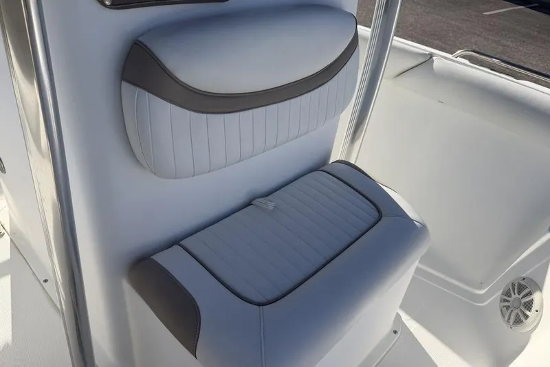 Slide: The Image of 2010 Sea Hunt Ultra 210 boat interior seating with gray and white upholstery. - 8