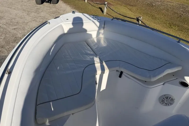 Slide: The Image of 2010 Sea Hunt Ultra 210 boat interior with white cushioned seating. - 9