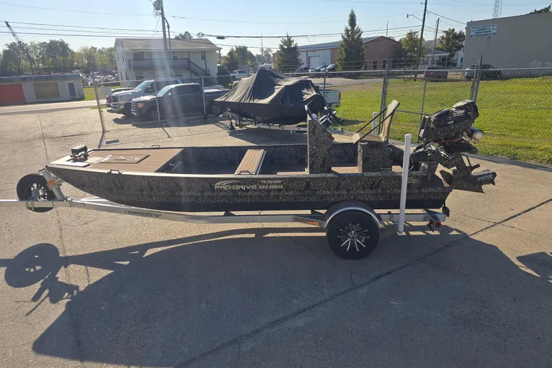 Slide: The Image of 2026 Pro-Drive 1856 SBX TD boat on trailer in outdoor setting. - 11
