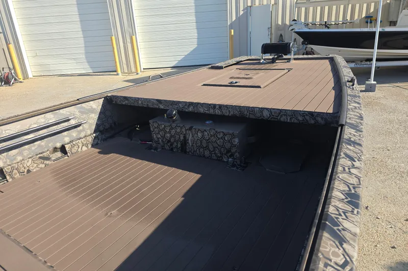 Slide: The Image of 2026 Pro-Drive 1856 SBX TD boat with camouflage design, parked outdoors. - 3