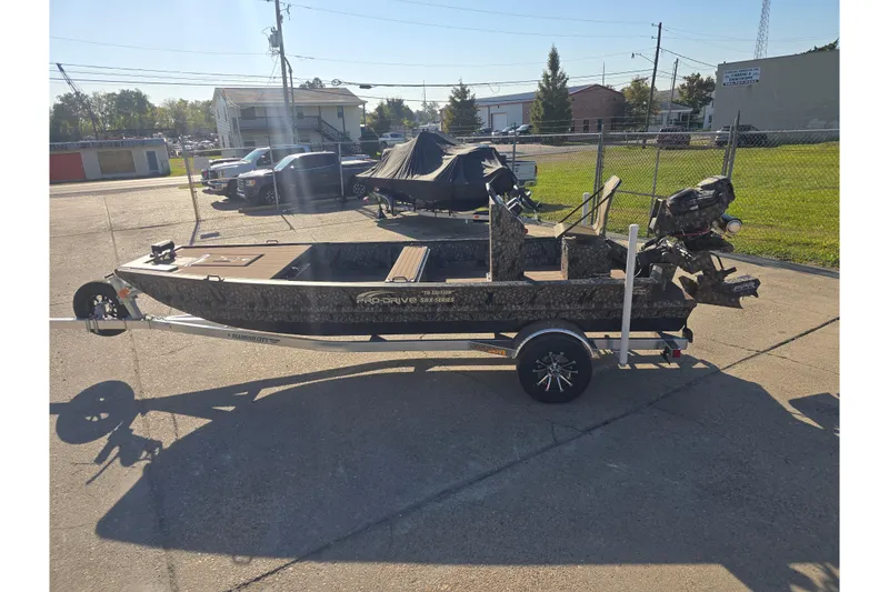 Slide: The Image of 2026 Pro-Drive 1856 SBX TD boat on trailer in sunny parking lot. - 5