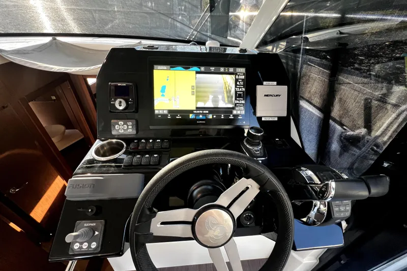 Slide: The Image of 2023 Beneteau Antares 11 Fly helm with navigation display and controls. - 10