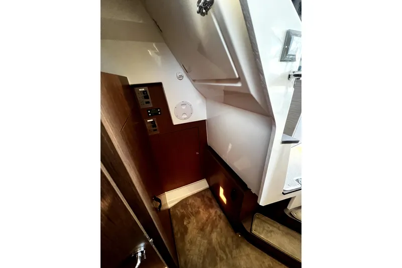 Slide: The Image of Interior view of 2023 Beneteau Antares 11 Fly, featuring wood paneling and control panels. - 13