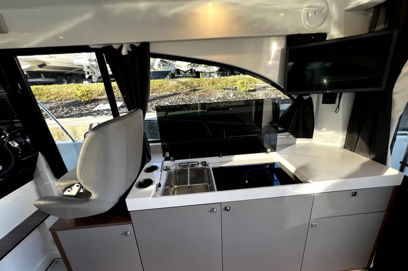 Slide: The Image of Interior of 2023 Beneteau Antares 11 Fly, featuring modern kitchen and seating area. - 7