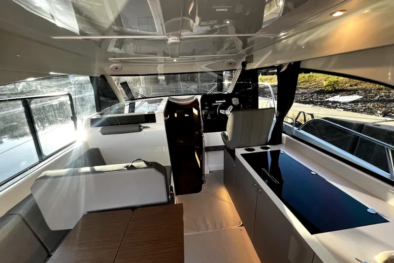 Slide: The Image of Interior of 2023 Beneteau Antares 11 Fly, featuring modern seating and navigation area. - 8