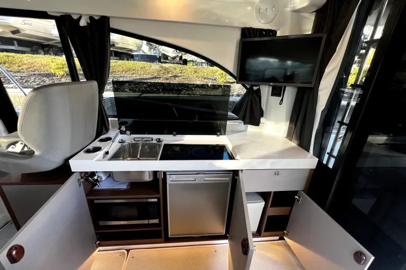 Slide: The Image of Modern kitchen area in 2023 Beneteau Antares 11 Fly yacht with appliances and storage. - 9