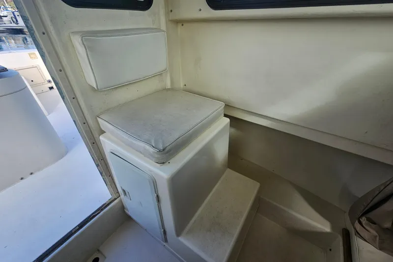 Slide: The Image of Interior of a 2000 Parker 2520 Sport Cabin boat with cushioned seating. - 13