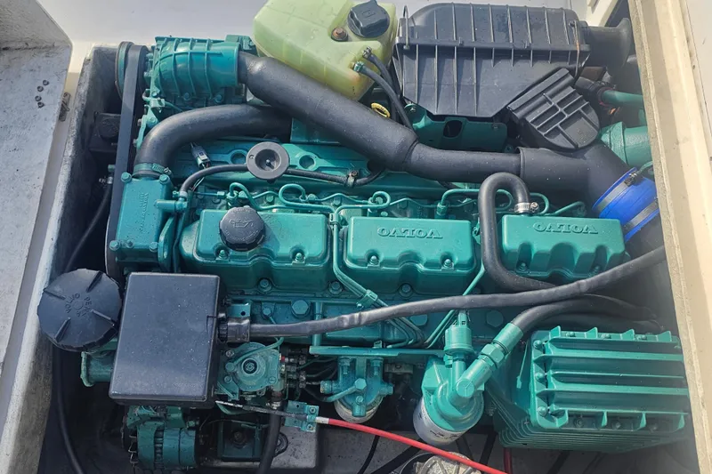 Slide: The Image of Engine compartment of a 2000 Parker 2520 Sport Cabin boat, featuring a Volvo engine. - 15