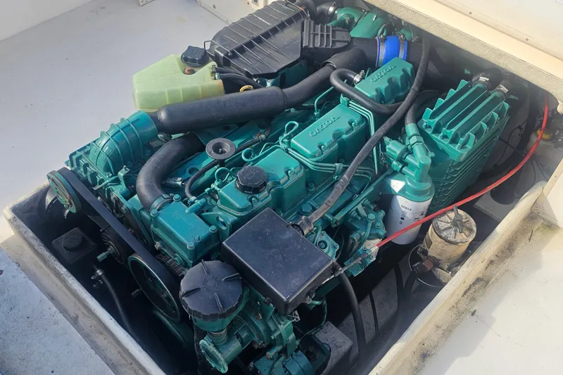 Slide: The Image of Engine compartment of a 2000 Parker 2520 Sport Cabin boat, showcasing detailed components. - 16
