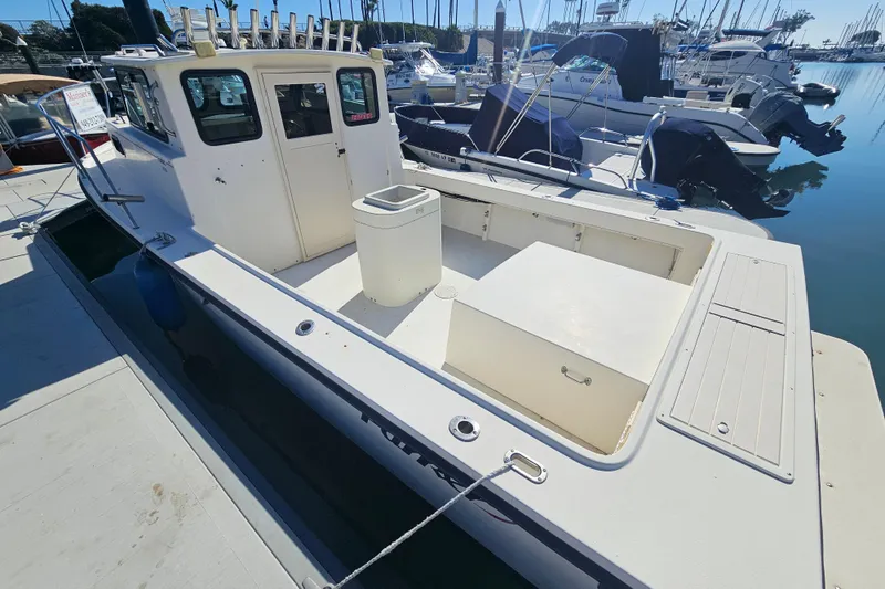 Slide: The Image of 2000 Parker 2520 Sport Cabin boat docked at marina, rear view. - 3