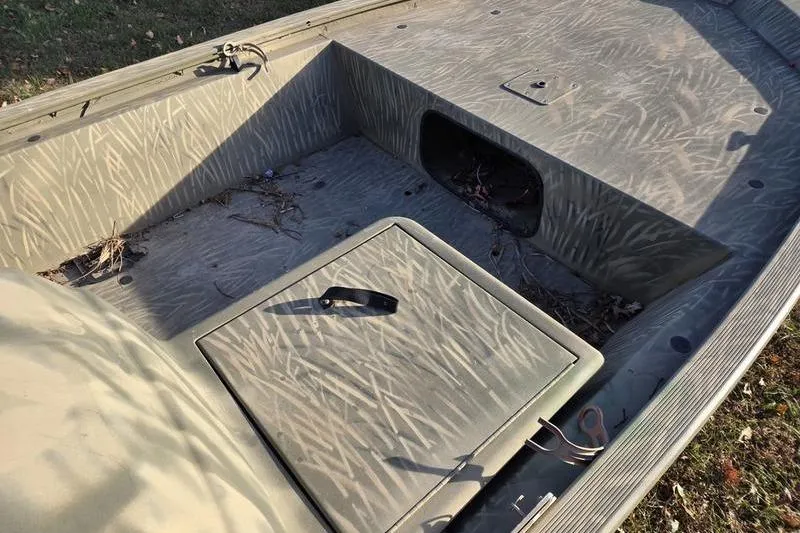 Slide: The Image of 2017 Tracker Grizzly 1648 MVX Jon boat interior with fuel tank and battery. - 5