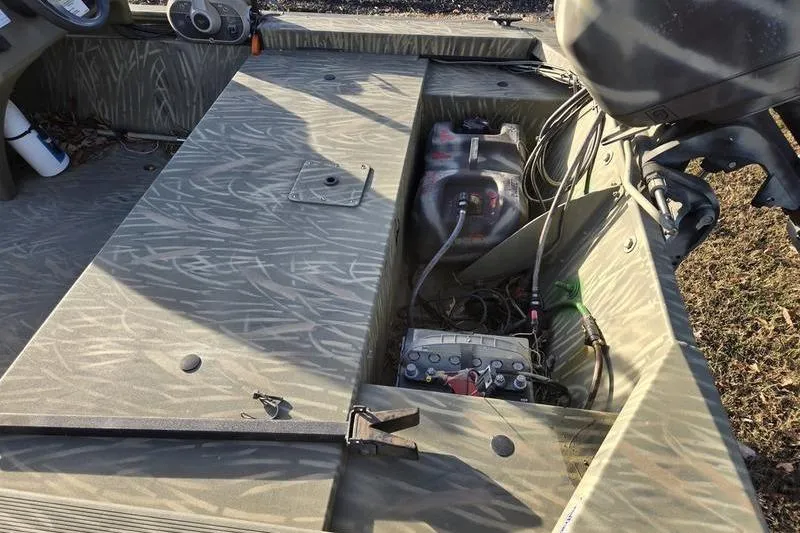 Slide: The Image of 2017 Tracker Grizzly 1648 MVX Jon boat on trailer, parked outdoors. - 6