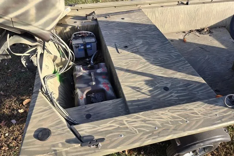 Slide: The Image of 2017 Tracker Grizzly 1648 MVX Jon boat interior with steering wheel and camouflage design. - 9