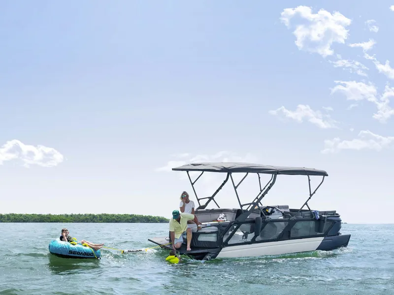 Slide: The Image of 2024 Sea-Doo Switch Cruise 21' 230 hp towing a tube on a sunny day. - 12