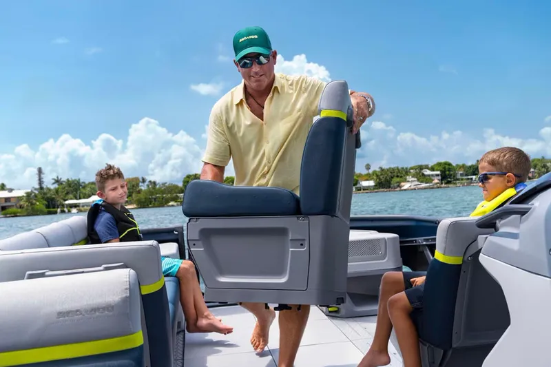 Slide: The Image of 2024 Sea-Doo Switch Cruise 21 on water, featuring adjustable seating and family enjoying the ride. - 9