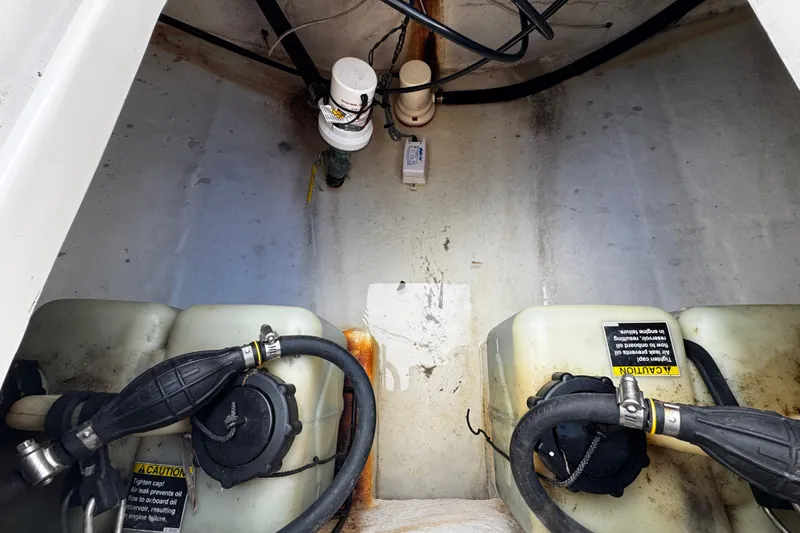 Slide: The Image of 2004 Dusky 33 boat engine compartment with fuel tanks and hoses. - 10