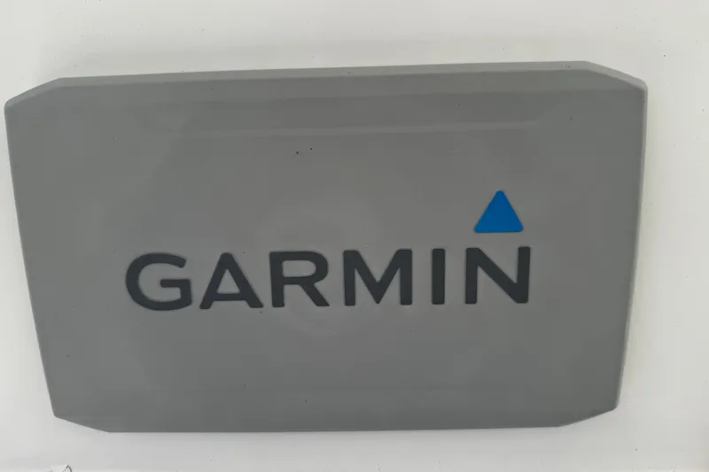 Slide: The Image of Gray Garmin device cover with blue triangle logo, compatible with 2004 Dusky 33 model. - 13