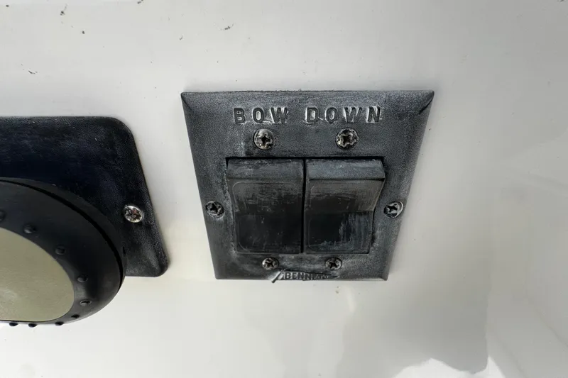 Slide: The Image of Boat control panel with "Bow Down" switches on a 2004 Dusky 33 model. - 17