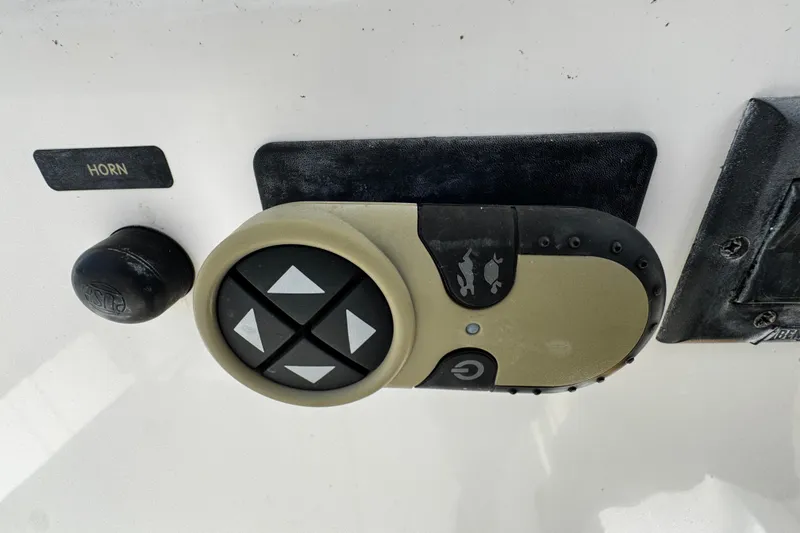 Slide: The Image of Control panel on a 2004 Dusky 33 boat with horn button and directional pad. - 18