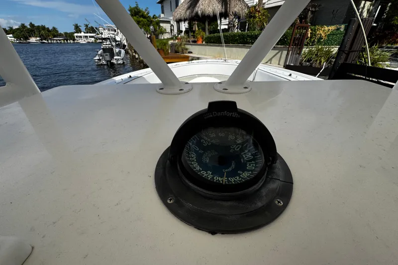 Slide: The Image of Compass on 2004 Dusky 33 boat, docked near waterfront homes. - 20