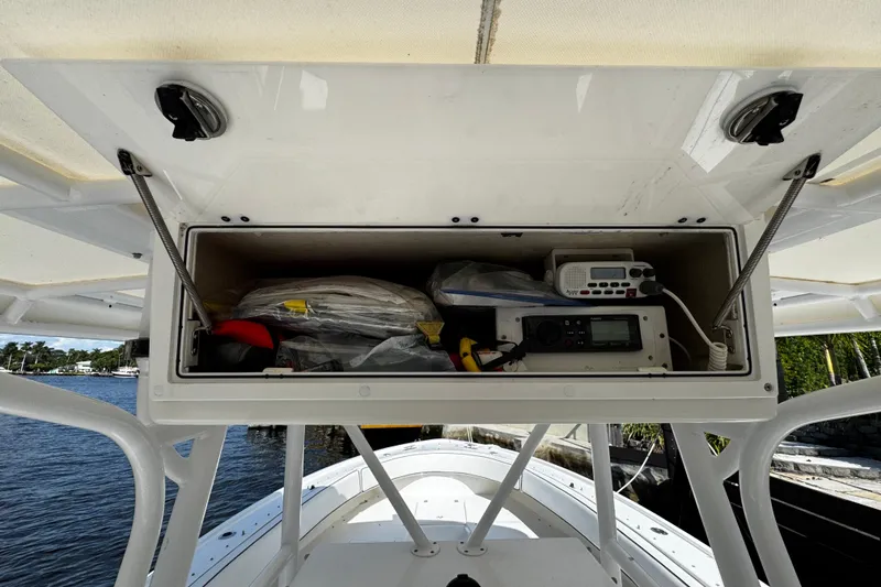 Slide: The Image of Storage compartment on a 2004 Dusky 33 boat, featuring marine equipment and supplies. - 23