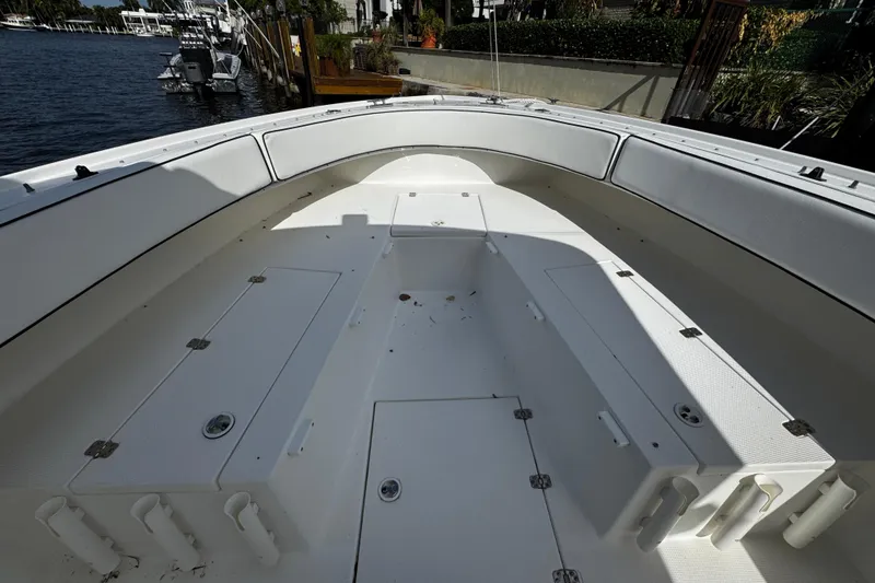 Slide: The Image of 2004 Dusky 33 boat interior with spacious seating and storage compartments. - 28