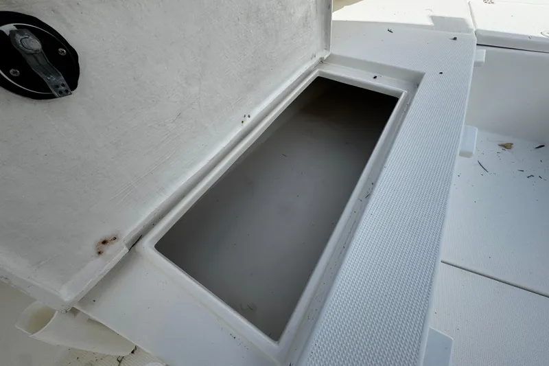 Slide: The Image of Open storage compartment on a 2004 Dusky 33 boat, showing interior details. - 30