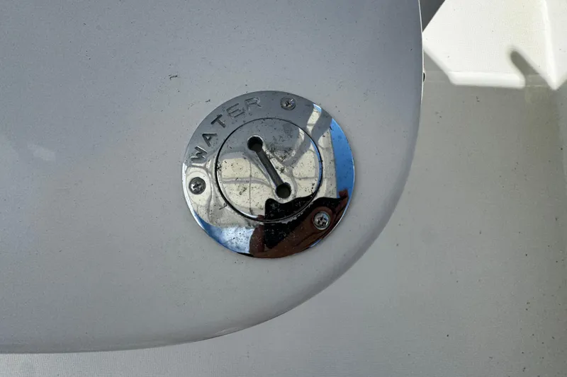 Slide: The Image of Water fill cap on 2004 Dusky 33 boat deck, chrome finish. - 34