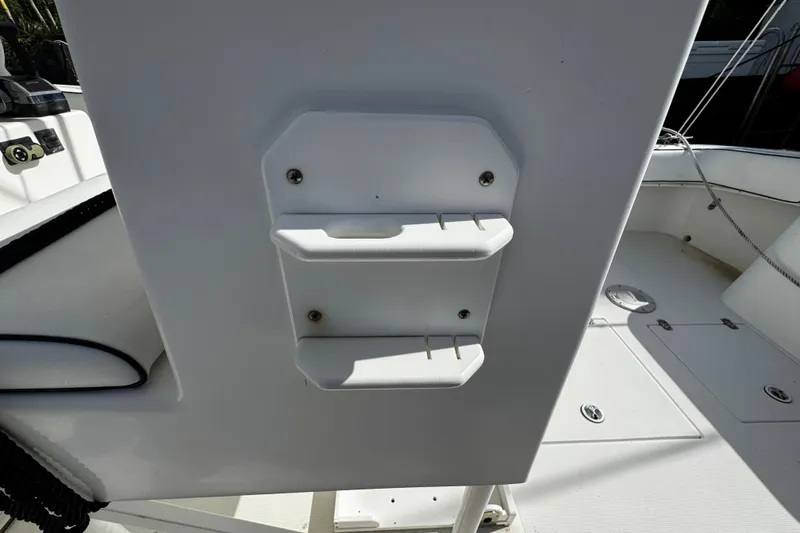 Slide: The Image of 2004 Dusky 33 boat interior with white console and storage compartments. - 41