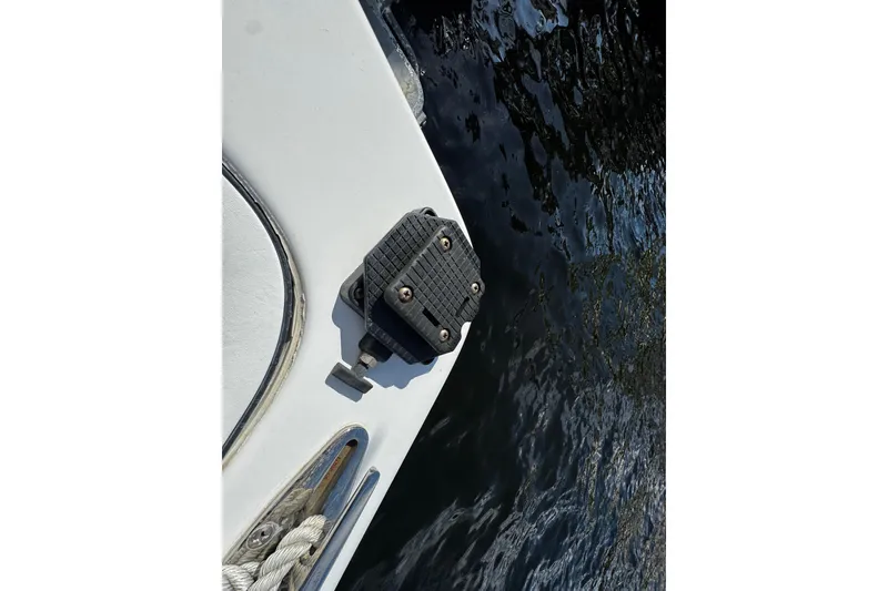 Slide: The Image of 2004 Dusky 33 boat detail with water reflection. - 42