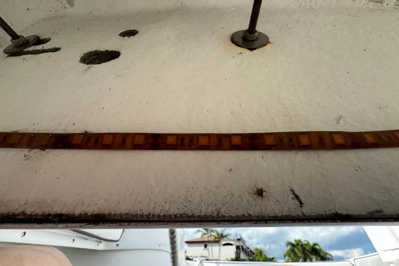 Slide: The Image of 2004 Dusky 33 boat underside with visible wiring and mounting hardware. - 46