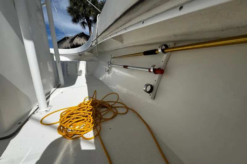 Slide: The Image of Interior of 2004 Dusky 33 boat with coiled yellow rope and mounted equipment. - 47