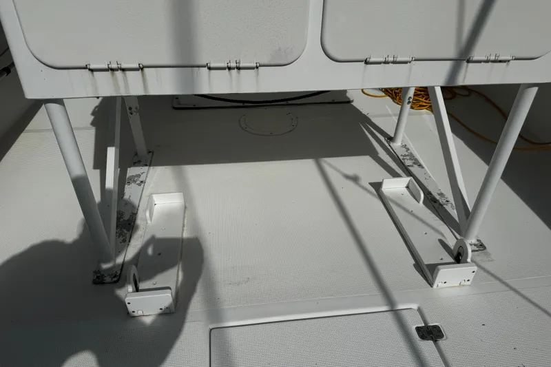 Slide: The Image of 2004 Dusky 33 boat interior showing seating support structure and deck details. - 49