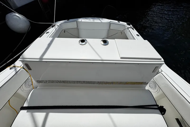 Slide: The Image of 2004 Dusky 33 boat interior with seating and storage compartments. - 5
