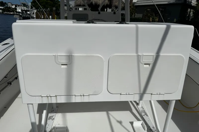 Slide: The Image of 2004 Dusky 33 boat interior with storage compartments and fishing rod holders. - 50