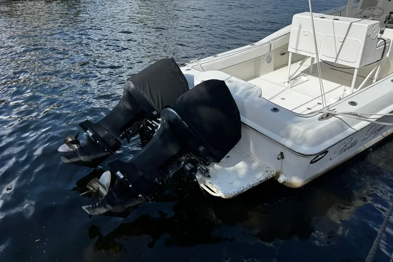 Slide: The Image of 2004 Dusky 33 boat with dual outboard motors on water. - 51