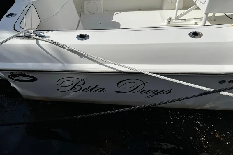 Slide: The Image of 2004 Dusky 33 boat named "Béta Days" docked with ropes. - 54