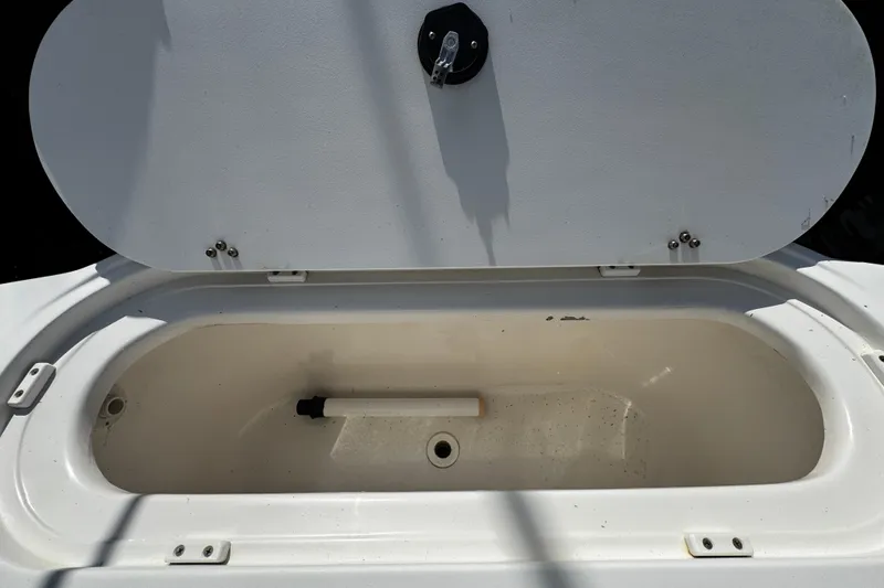 Slide: The Image of Open storage compartment on a 2004 Dusky 33 boat, featuring a clean interior. - 7