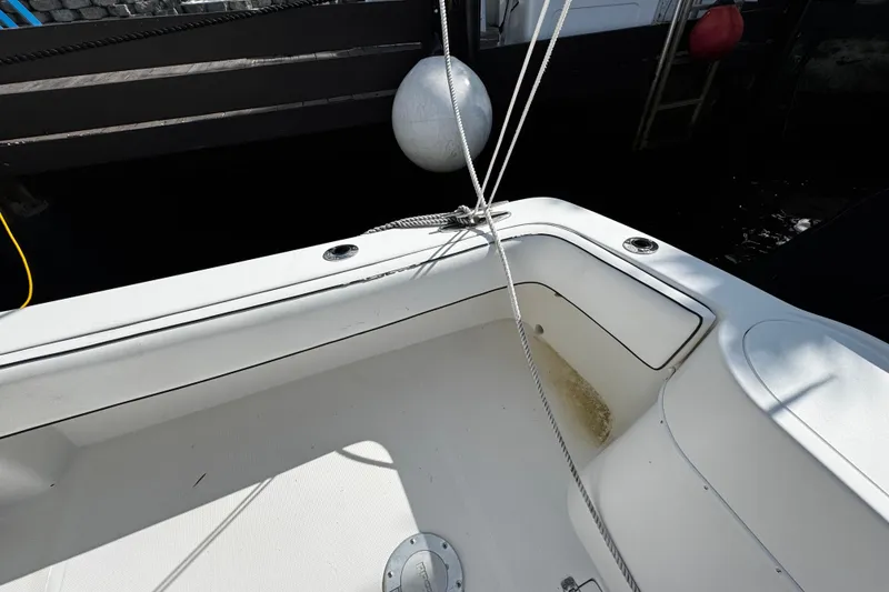 Slide: The Image of 2004 Dusky 33 boat interior with white deck and mooring lines. - 9
