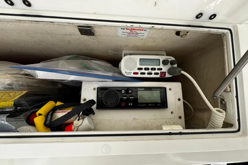 Slide: The Image of Storage compartment in a 2004 Dusky 33 boat with radio equipment and accessories. - 22