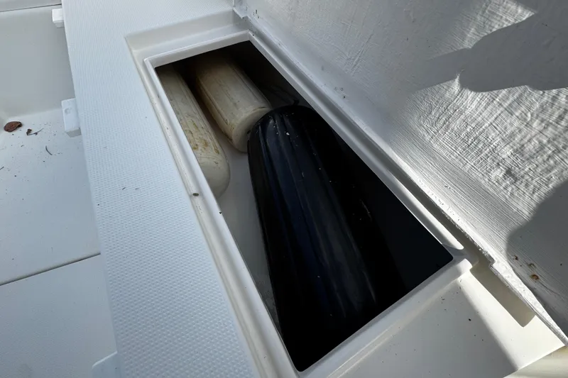 Slide: The Image of Storage compartment on a 2004 Dusky 33 boat with fenders inside. - 31