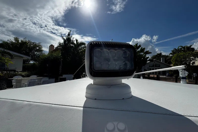 Slide: The Image of 2004 Dusky 33 boat spotlight under a bright sunlit sky. - 38