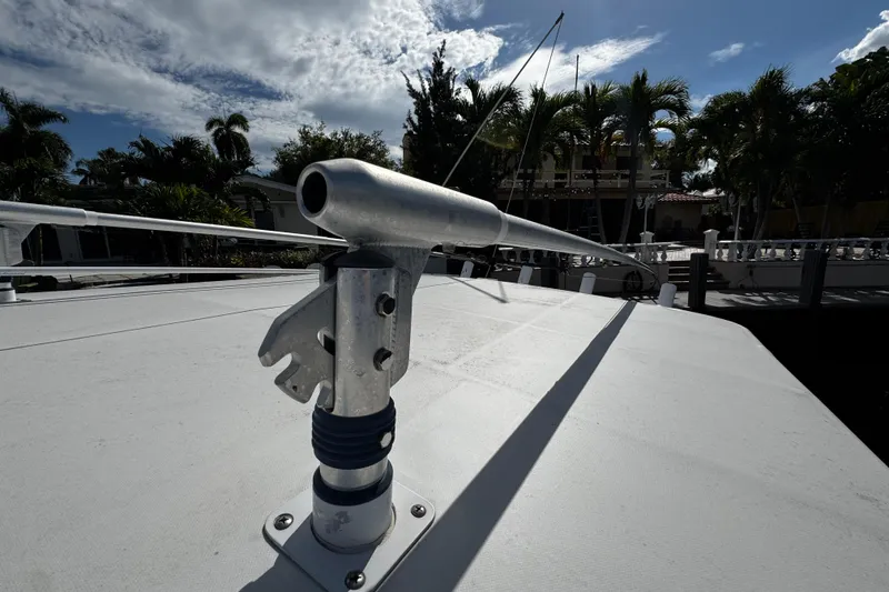 Slide: The Image of Rooftop view of a 2004 Dusky 33 boat with antenna, surrounded by palm trees. - 40
